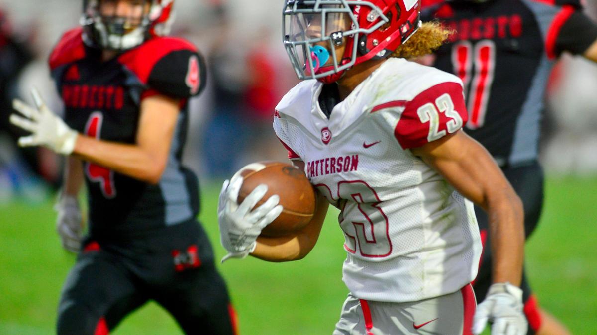 Patterson running back Jordan Imada runs past Modesto defenders en route to scoring a touchdown during a game between Modesto High School and Patterson High School at Gregori High School in Modesto California on September 13, 2019.