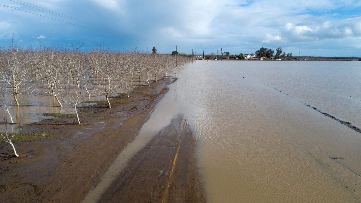 Water from the Orestimba Creek flooded an orchard and farmland along Anderson Road in Newman, Calif., Tuesday, Jan. 10, 2023.