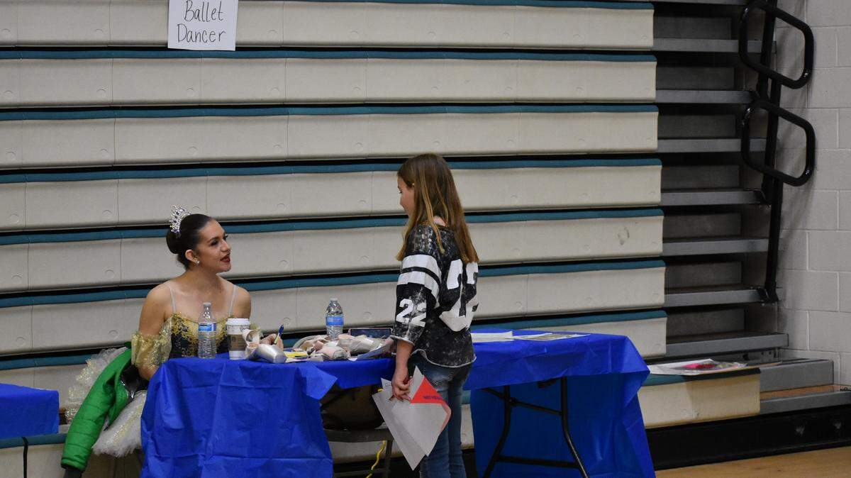 Brittnie King, a first soloist with Central West Ballet in Modesto, talks with a final student as the career fair at Glick Middle School comes to a close late Wednesday morning, March 13, 2019.