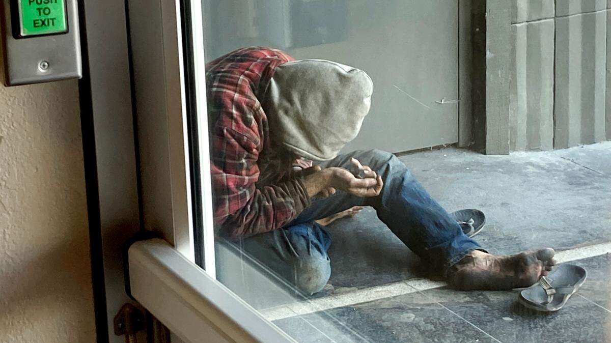 A homeless person rests in the doorway of a J Street office building in Modesto, Calif., Friday, July 17, 2020.