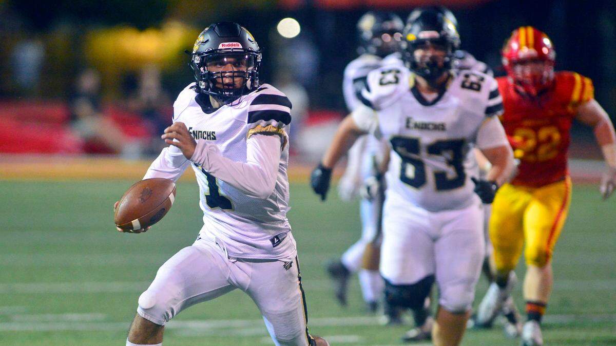 Enochs quarterback Adam Ammar (1) scrambles upfield during a game between Oakdale and Enochs at Oakdale High School in Oakdale CA on September 23, 2022.