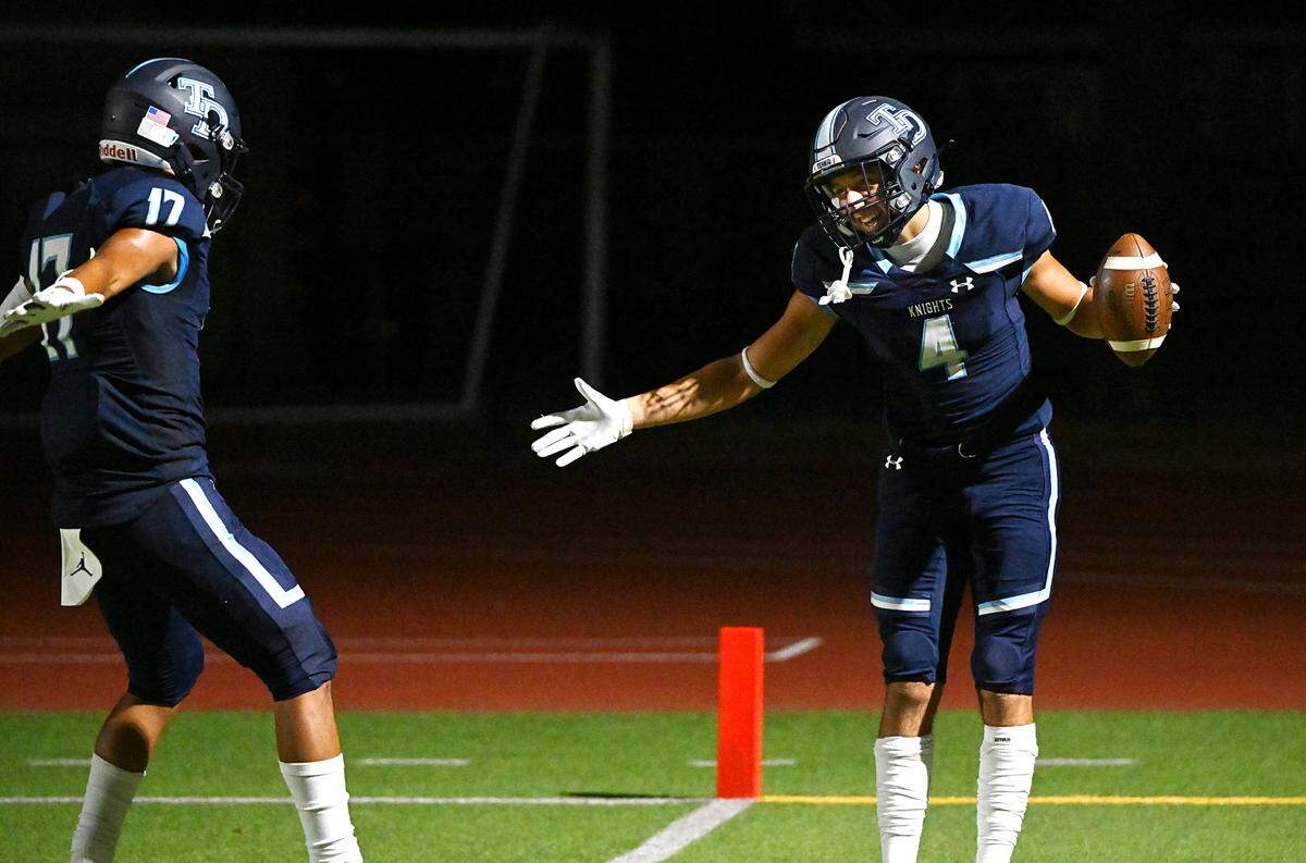 Downey’s Joseph Ramirez (4) and Jayceon Sloan (17) celebrate a touchdown during the game with Lincoln at Downey High School in Modesto, Calif., Friday, August 18, 2023.