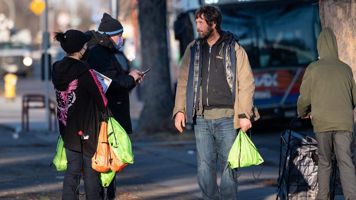 Volunteers Damien Martinez and Emily Owen surveyed unsheltered and asked them a series of questions during the annual count of Stanislaus County’s homeless in Modesto, Calif., on Thursday, Feb. 24, 2022. The U.S. Department of Housing and Urban Development requires local communities to conduct the annual point-in-time count to receive homeless funding.