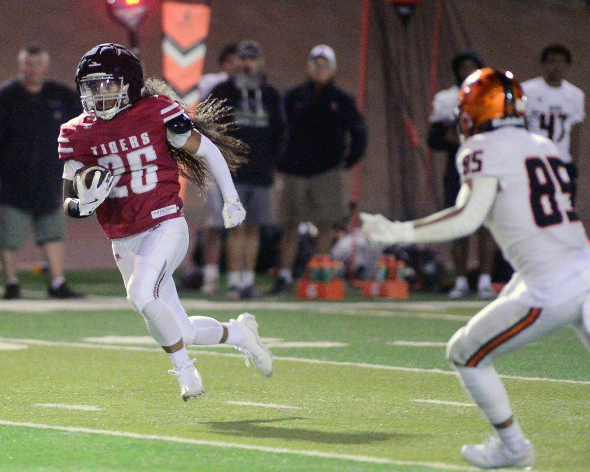 Patterson receiver Romeo Manu (26) sprints past a Merced defender during a game between Patterson High School and Merced High School at Patterson High on Aug. 23, 2024.