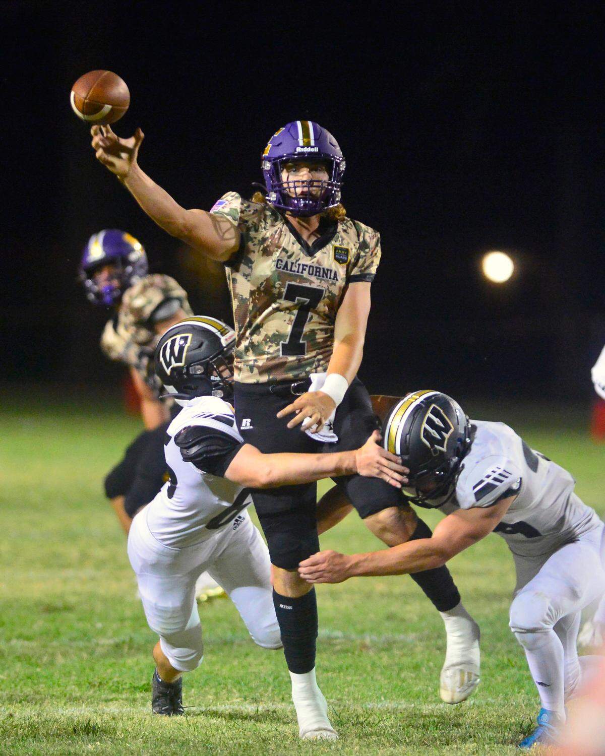 Escalon quarterback Donovan Rozevink (7) throws the ball over the middle while being pressured during a game between Escalon and Windsor at Escalon High School in Escalon California on September 2, 2022.
