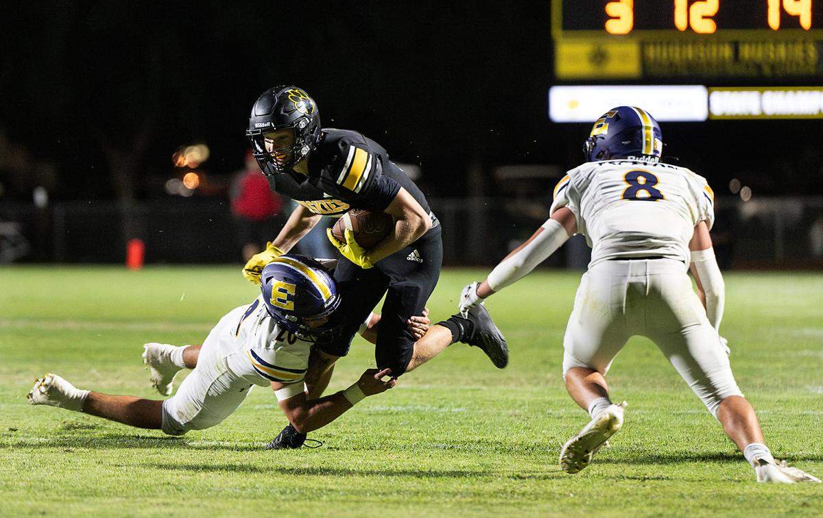 Hughson’s Larkin Meyer runs the ball as Escalon’s Nico Franzia defends at Hughson High School in Hughson, Calif., Friday, Sept. 29, 2023.