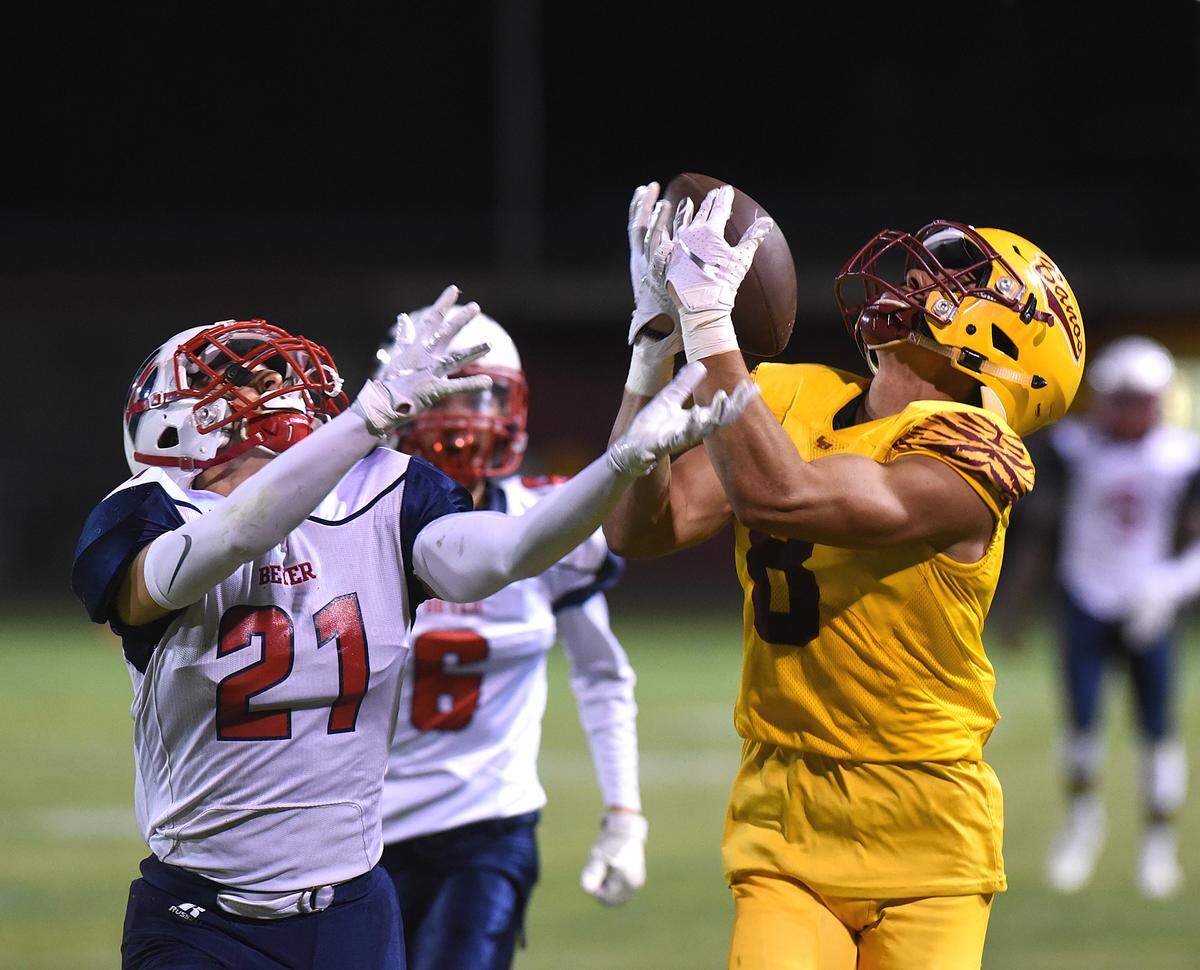 Los Banos receiver, Landon Ramos, right, completes a long pass in the fourth quarter against Beyer defender, Ethan Shiffler at Loftin Stadium Fri., Sept. 20, 2019 in Los Banos. Beyer defeated Los Banos 14-7.