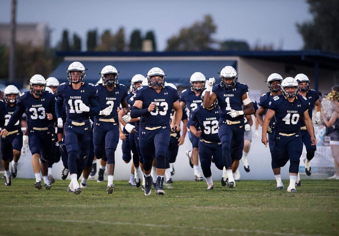 Central Catholic players take the field before the Holy Bowl game with St. Mary’s at Central Catholic High School in Modesto , Calif., August 31, 2018. 