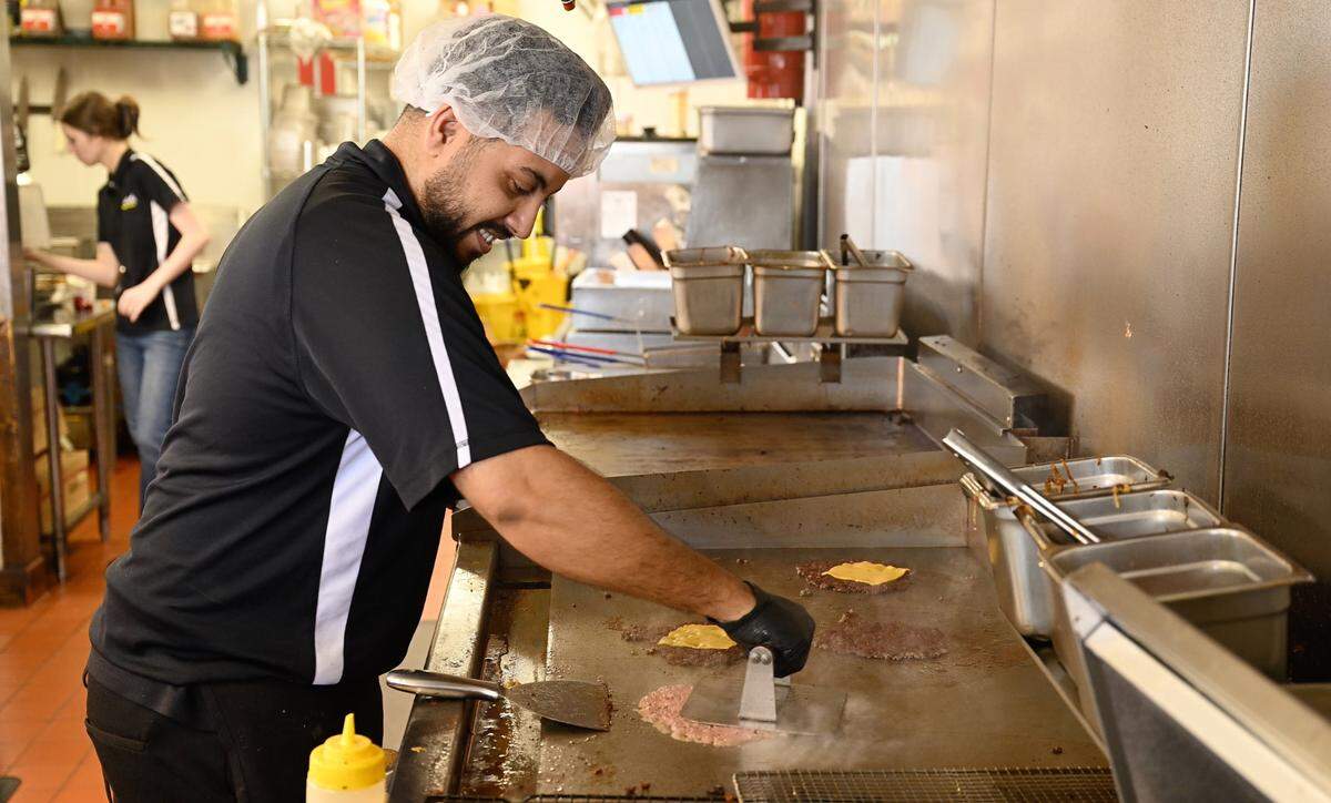 Co-Owner Mohammad Mohammad flattens ground beef during the making of a smash burger at Smash Bros Burgers in Merced, Calif., Tuesday, March 25, 2025.