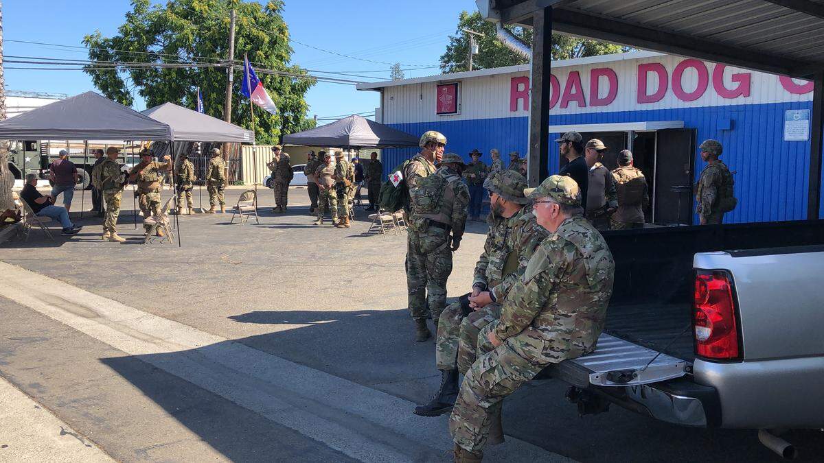 Members of Echo Company, 2nd Infantry Regiment, California State Militia, gather at Road Dog Cycle in Denair on Saturday morning, June 6, 2020.