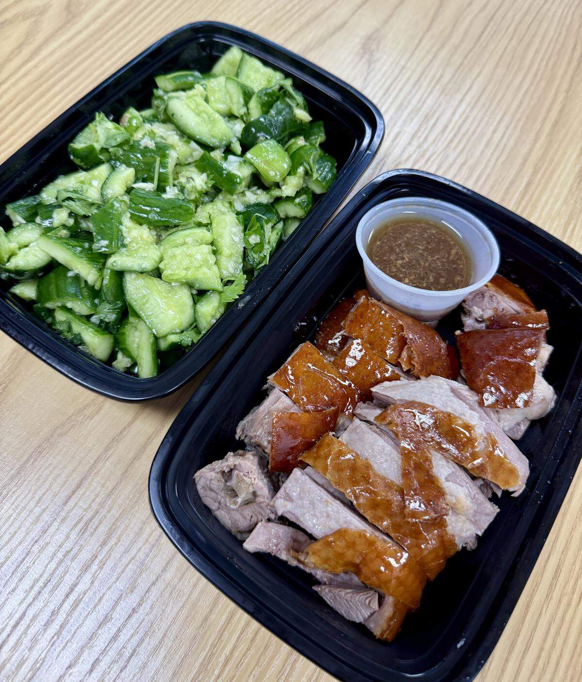 One of the most popular dishes at Fat Boy Roasted Delights in Modesto, Calif., is roasted duck. Also pictured is cucumber salad.