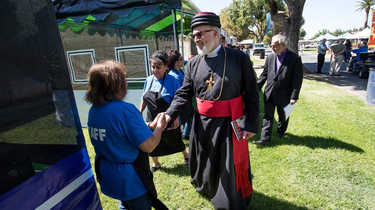Bishop of the Assyrian Church of the East Mar Awa Royel greets people during the Assyrian Festival in Turlock, Calif., on Saturday, Sept. 15, 2018. 