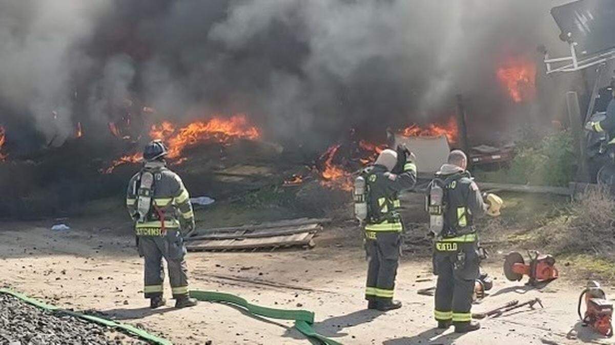 Modesto firefighters stand by fire auto dismantling shop on Kiernan Ave in Salida on March 3, 2023.