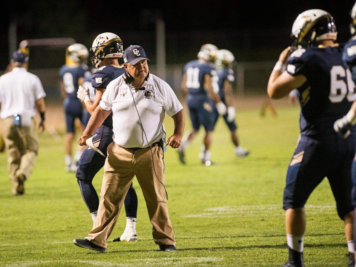 Central Catholic’s coach Roger Canepa talks to his defensive players during the Holy Bowl game with St. Mary’s at Central Catholic High School in Modesto , Calif., August 31, 2018. 
