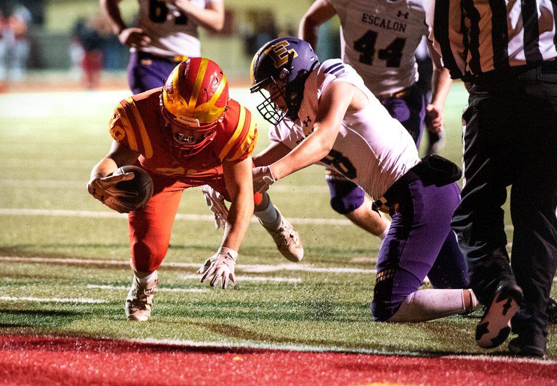 Oakdale’s Yahir Ayala reaches over the goal line for a touchdown during the Valley Oak League game with Escalon in Oakdale, Calif., on Friday, March 19, 2021. Oakdale won the game 38-35.