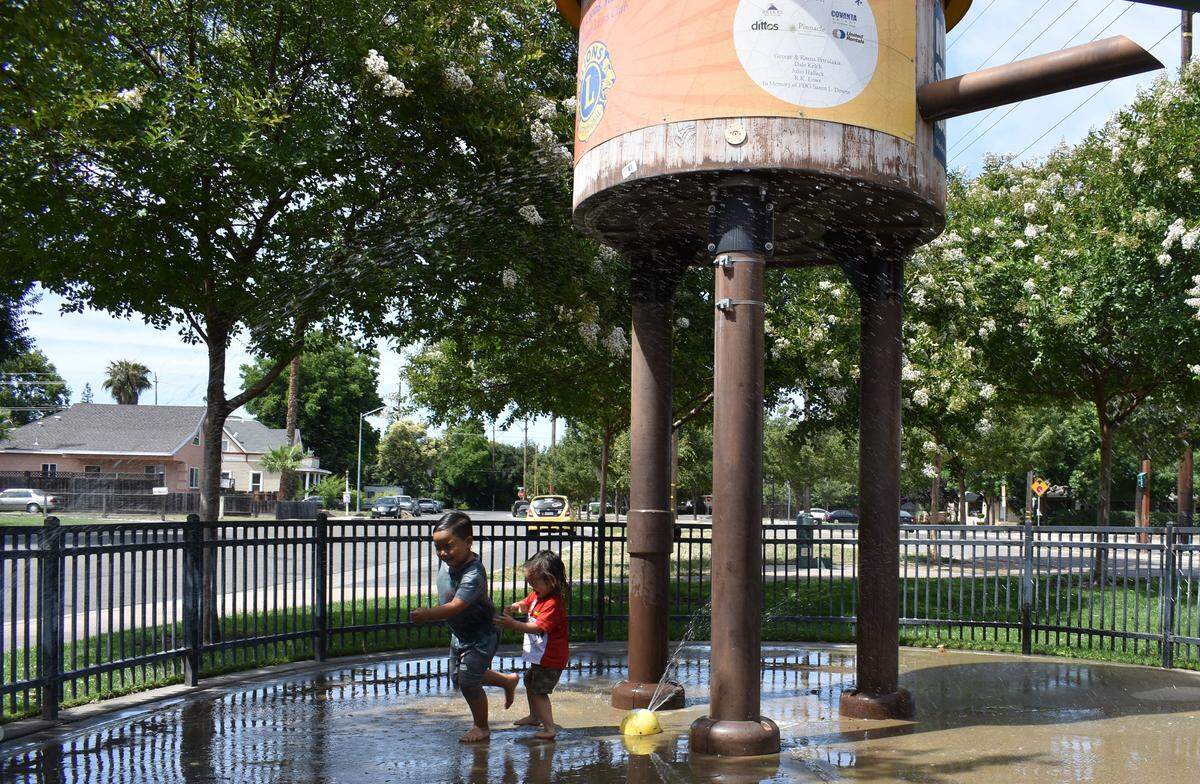 Andre Roth, 6, and little brother Sebastian, 2, beat the heat by playing on the Lions Junction splash pad on the Virginia Corridor on Sunday, June 9, 2019.