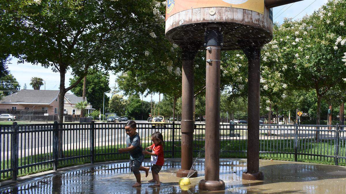 Andre Roth, 6, and little brother Sebastian, 2, beat the heat by playing on the Lions Junction splash pad on the Virginia Corridor on Sunday, June 9, 2019.