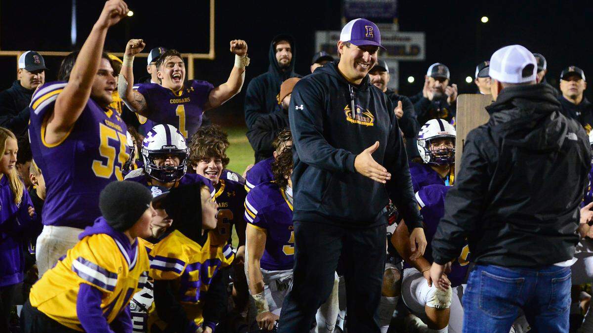 Escalon Head Coach is presented the 2022 Division 4-AA NorCal plaque while his team celebrates after the 2022 CIF NorCal Division 4-AA Bowl Game between Escalon High School and Pleasant Valley High School at Escalon High School in Escalon, Calif. on December 2, 2022. Escalon won the game 42-20.