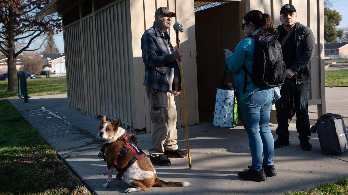 Volunteers Tiffany Ornells and Matt Orante talk with David Turner during Stanislaus County’s point in time count of the homeless population in Modesto, Calif., Thursday, Jan. 26, 2023.