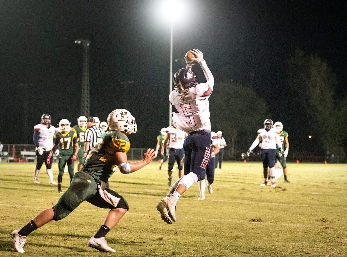 Modesto Christian’s Mario Hernandez intercepts a pass in the end zone during the Trans Valley League game at Hilmar High School in Hilmar, Calif., on Friday, Oct. 12, 2018. Modesto Christian won the game 24-21.