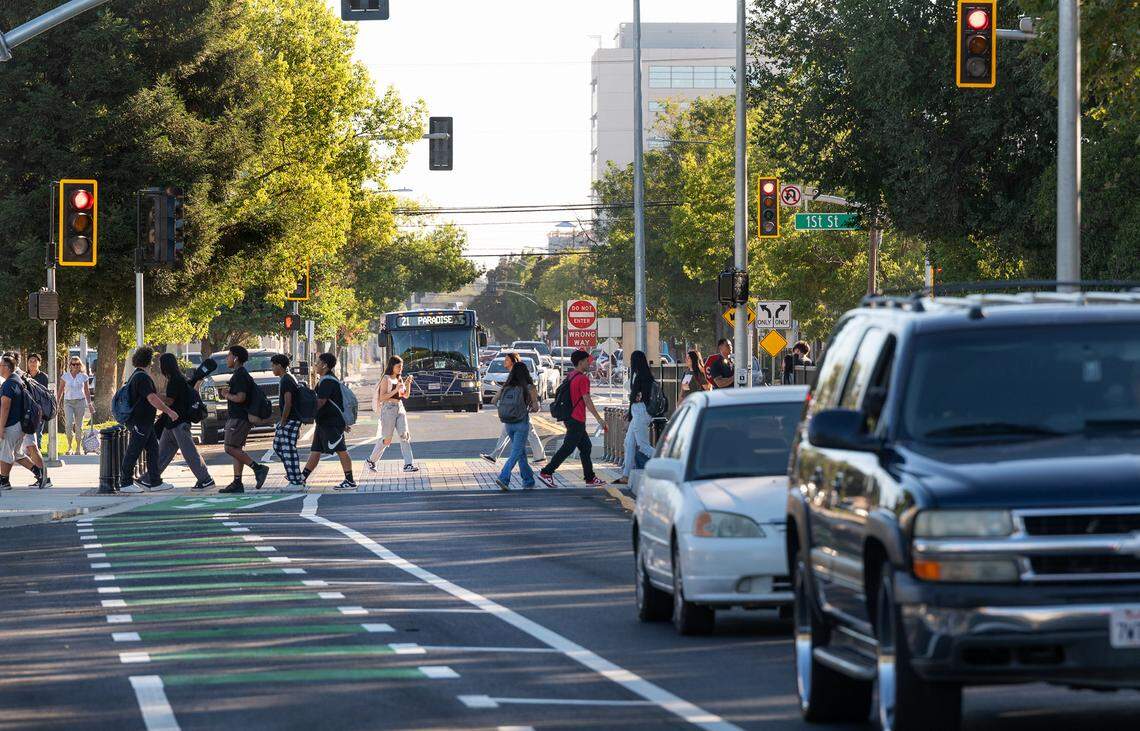 Students use a newly widened crosswalk outside Modesto High School in Modesto, Calif., Tuesday, Aug. 20, 2024. The city recently reduced vehicle traffic to two lanes added bicycle lanes and improved the crosswalks around the school.