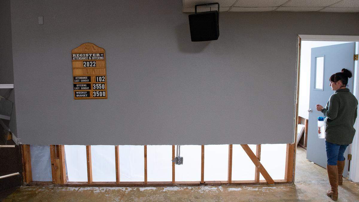 Hughson Christian School principal Sheila Parnell looks at the damage from a sewer leak inside the Church of Christ chapel in Hughson, Calif., Tuesday, Jan. 31, 2023. The church is stuck between the city and a city contractor, and without working bathrooms after a sewer project misfired in December.