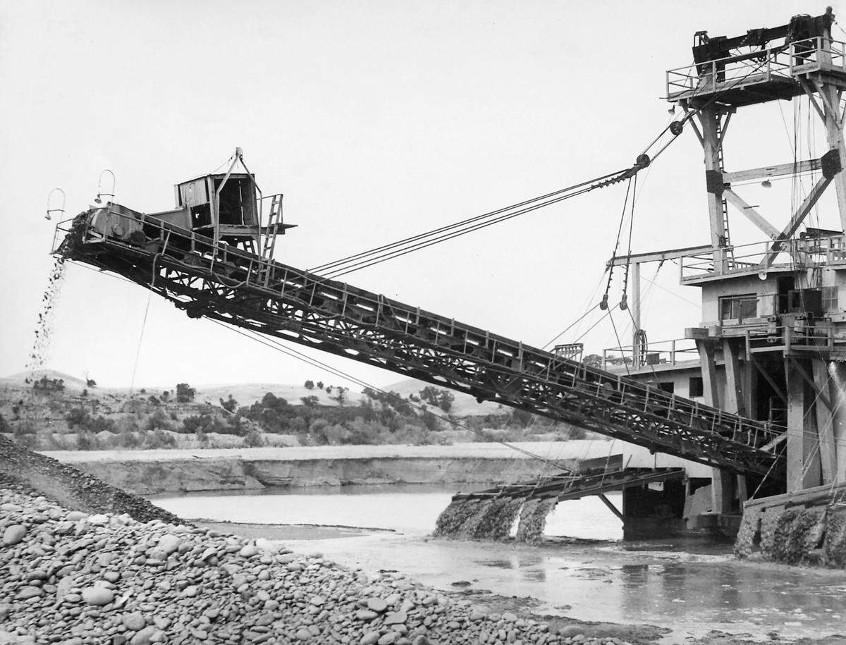 A dredging machine extracted gold along the Tuolumne River at La Grange, California, from 1938 to 1951. It damaged salmon habitat that is being restored in September 2024 by the Tuolumne River Trust and other parties.
