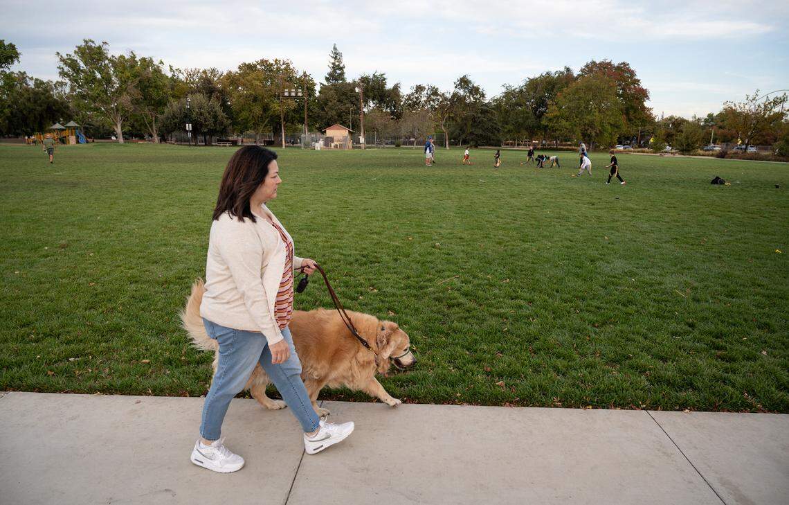 Monique Sanders walks her dog in Modesto, Calif., on Tuesday, Oct. 19, 2021. 