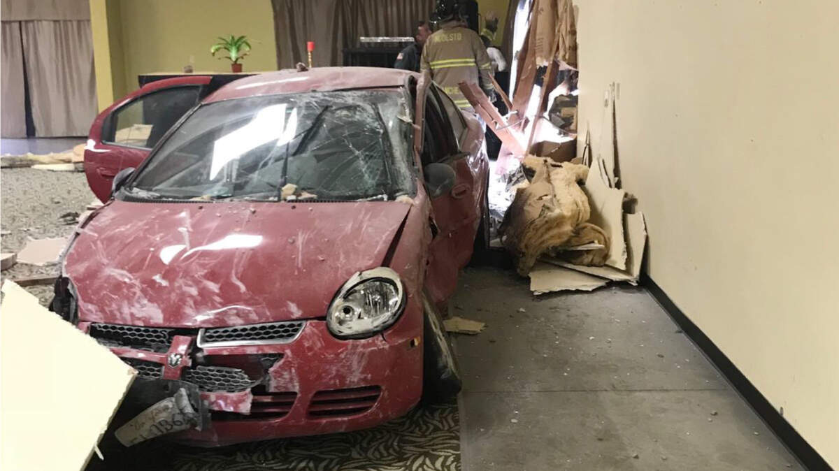 A car came to rest inside of a building after a crash at the corner of G and Sixth streets Thursday, March 15, 2018.