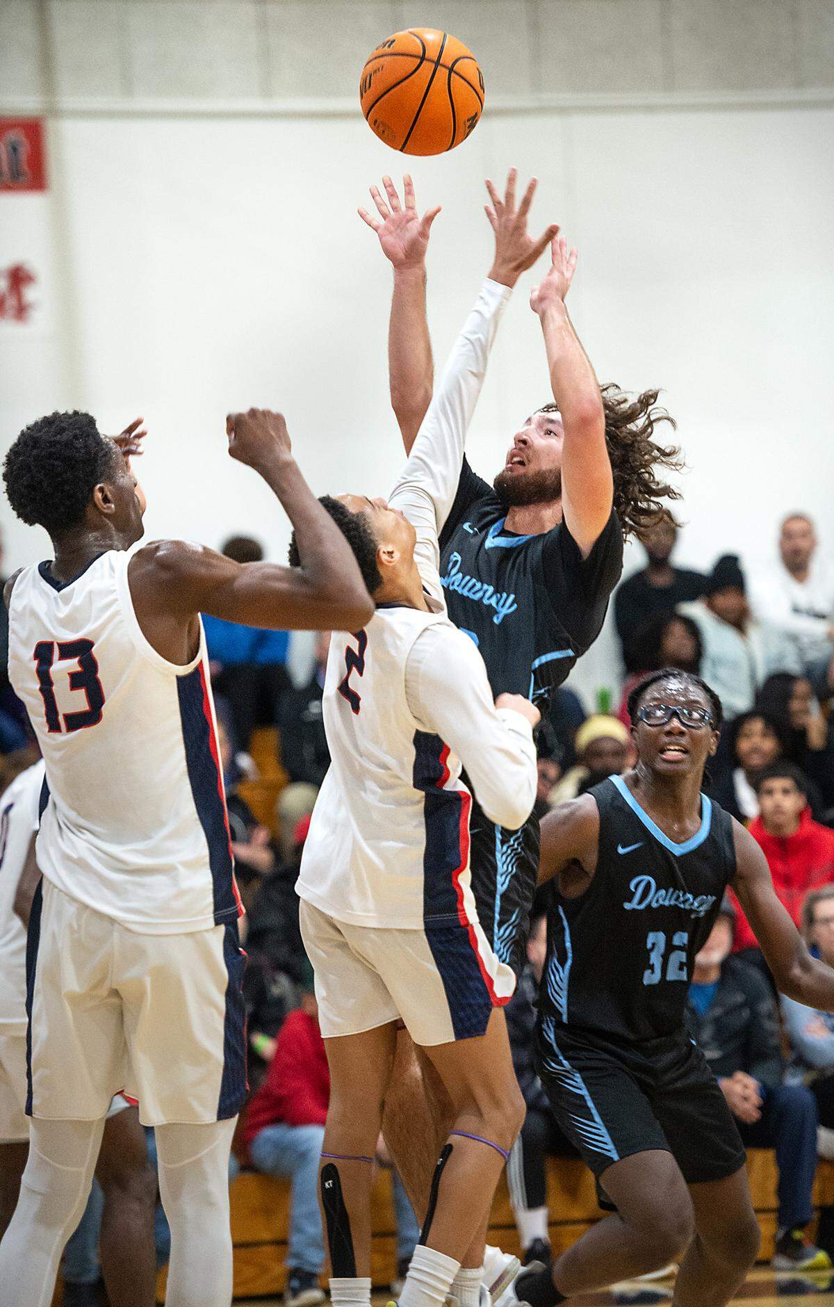 Downey’s Camden Rush scores over Modesto Christian’s Rashod Cotton during the Modesto Christian Holiday Hoop Classic in Salida, Calif., Tuesday, Dec. 27, 2022. MC won the game 44-37.