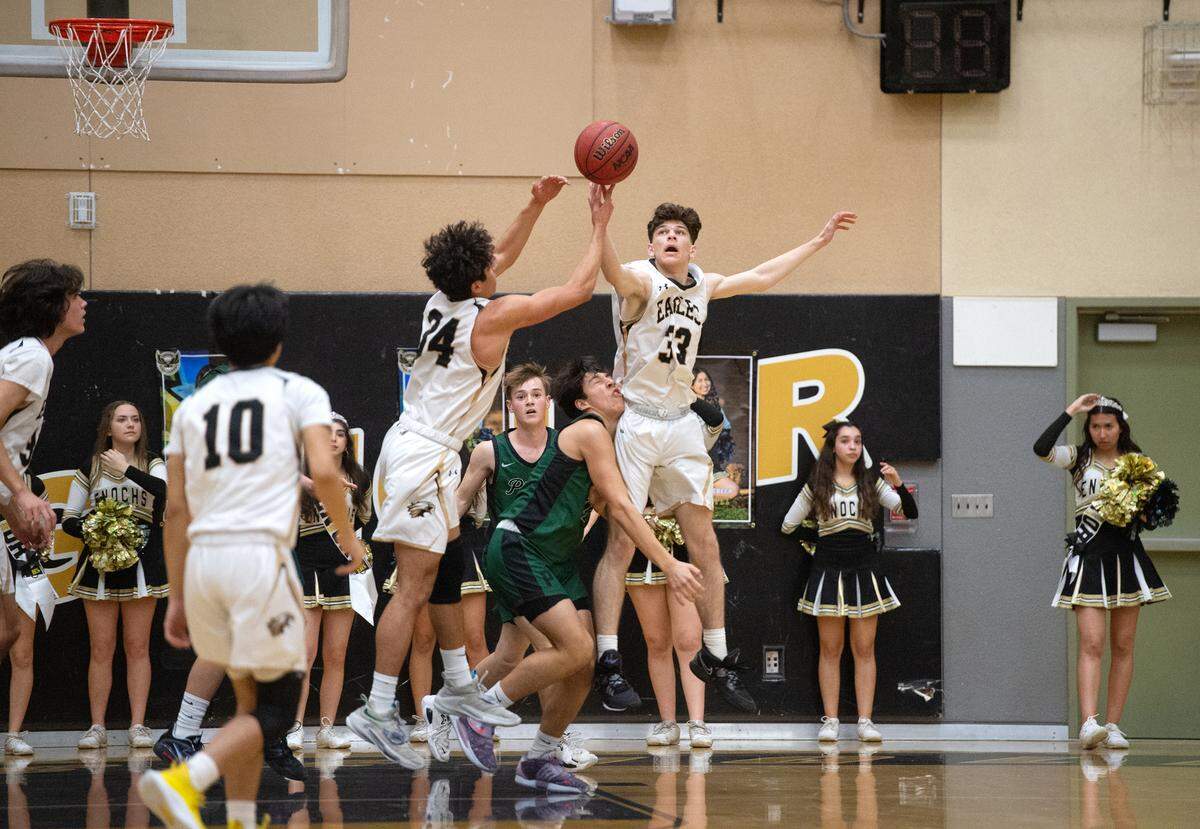 Enochs’ Francis Gates (33) and Ramiz Haddad (24) battle for a rebound during the Central California Athletic League game with Pitman at Enochs High School in Modesto, Calif., Friday, Feb. 10, 2023.