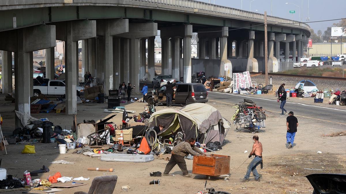 In this November 2018 photo, people work to move out of a homeless camp of about 50 to 75 residents living under the Golden State Boulevard overpass in southwest Turlock. Stanislaus County leaders’ priority efforts for 2023 include a new approach for reducing homelessness.