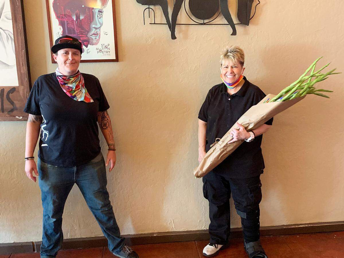 New owner Heather Elkins (left) and former longtime owner Lorena Loftis stand together inside downtown Modesto’s Deva Cafe, which was sold this week.