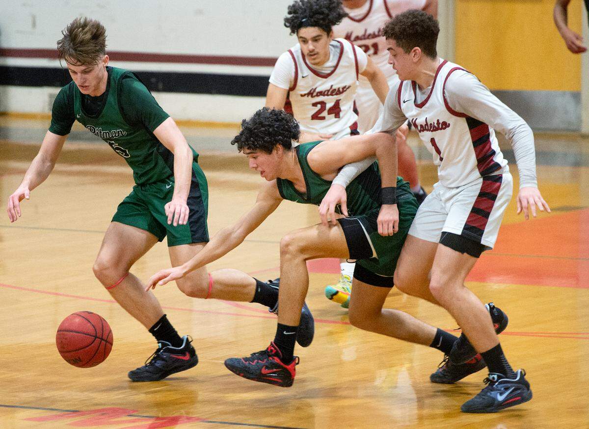 Pitman and Modesto players chase a loose ball during a Central California Athletic League game with Modesto during at Modesto High School in Modesto, Calif., Friday, Jan. 13, 2023.