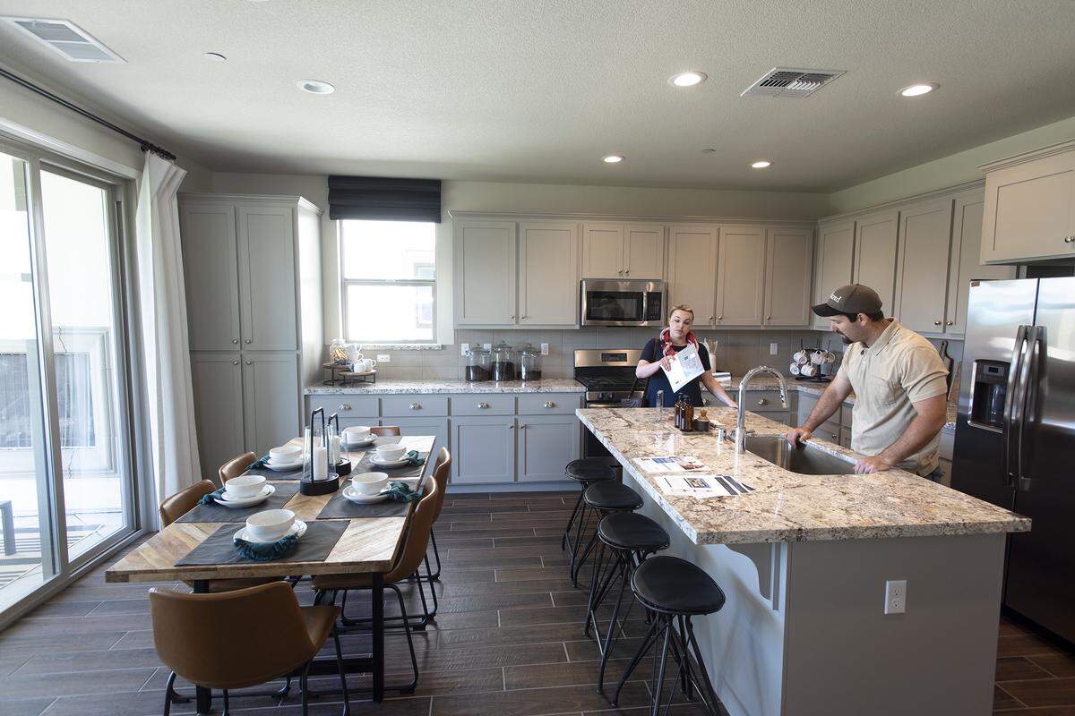 Prospective home buyers Stephen and Lexie Greer look at a kitchen at Icon at Inspiration, a Florsheim Home development, adjacent to the Vintage Faire Mall in Modesto, Calif., Saturday, July 20, 2019.