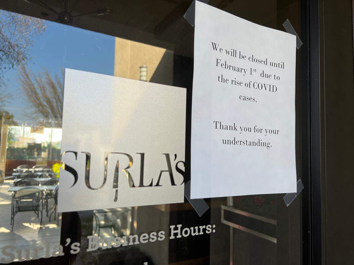A sign on Modesto, Calif.’s Surla’s restaurant announcing its temporary closure due to the COVID-19 surge on Jan. 12, 2022.