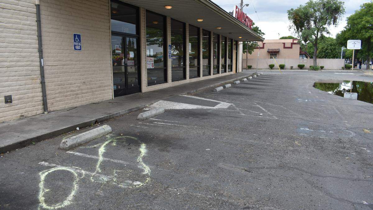 Richard Lane of Modesto was critically injured in a hit-and-run collision the night of April 13 in this parking lot of the closed Salvation Army Family Store on Yosemite Boulevard. He died 29 days later, and police are looking for the driver who struck him. The paint, sprayed by police, shows where Lane and his belongings were on the ground.