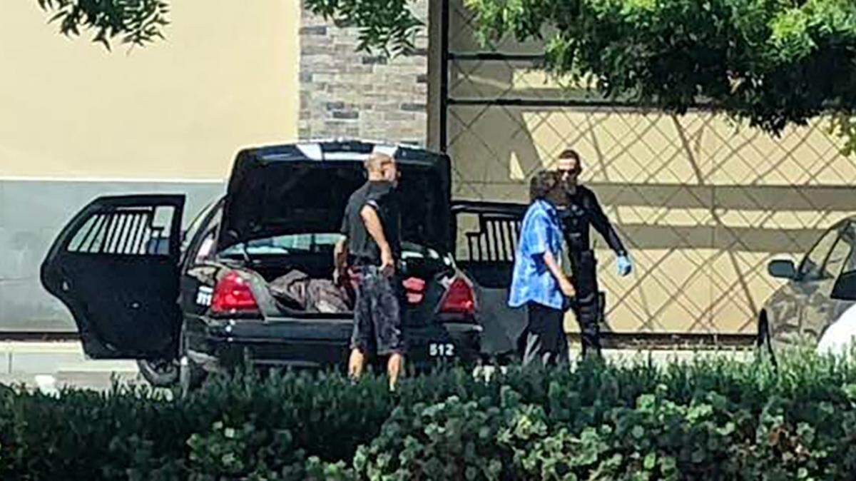 An Escalon officer drops off two homeless people at Rite Aid on McHenry Avenue last week.