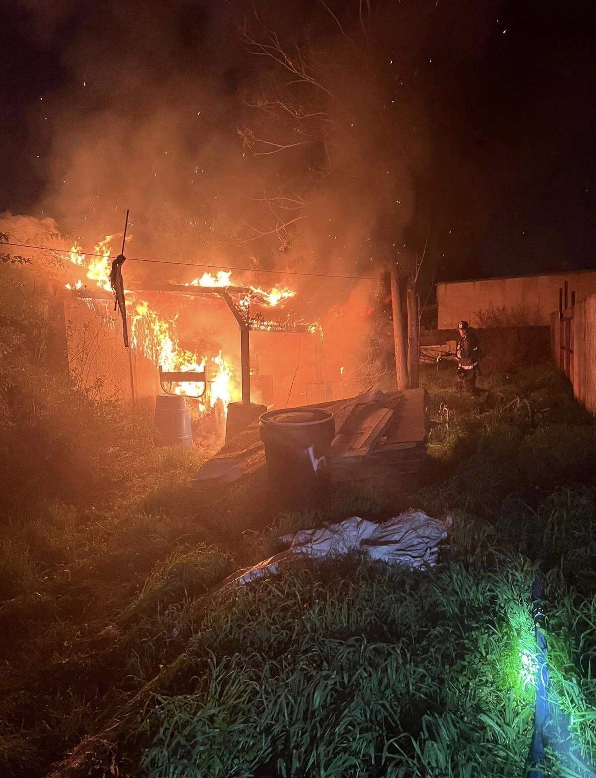 Heavy flames and smoke rise from a structure fire in Turlock shortly before 3 a.m. Wednesday. Investigators later ruled the fire an arson and arrested a suspect.