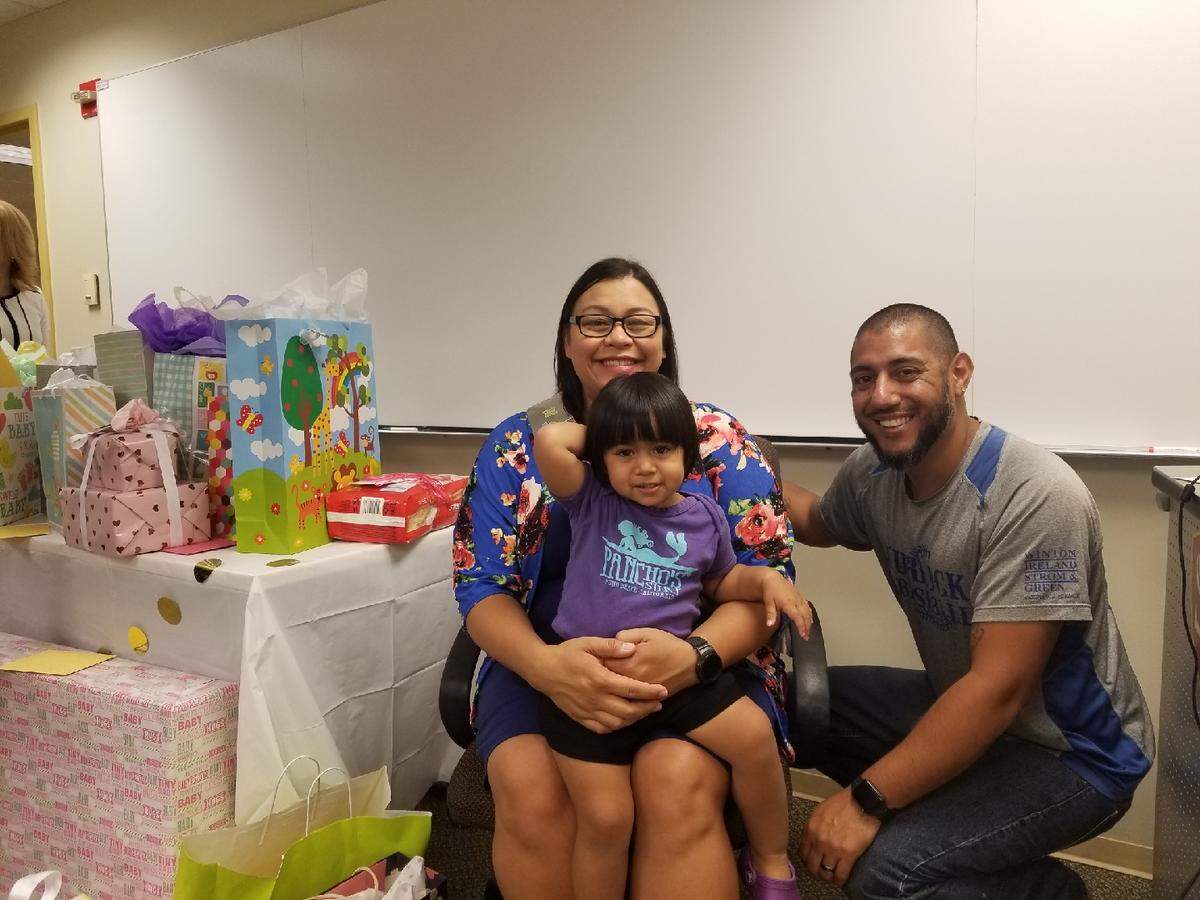 Meshell Alcantar; her husband, Robert; and their daughter, Nora, at a baby shower hosted by the CSU Stanislaus human resources department in September 2018. Meshell was fired soon after.