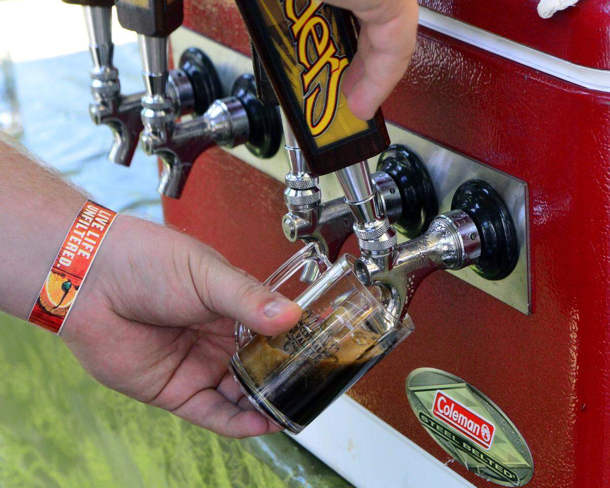Stuart Sloan pours a Founders beer on tap during the Central Valley Brewfest at the Stanislaus County Fairgrounds in Turlock California on May 14, 2016.