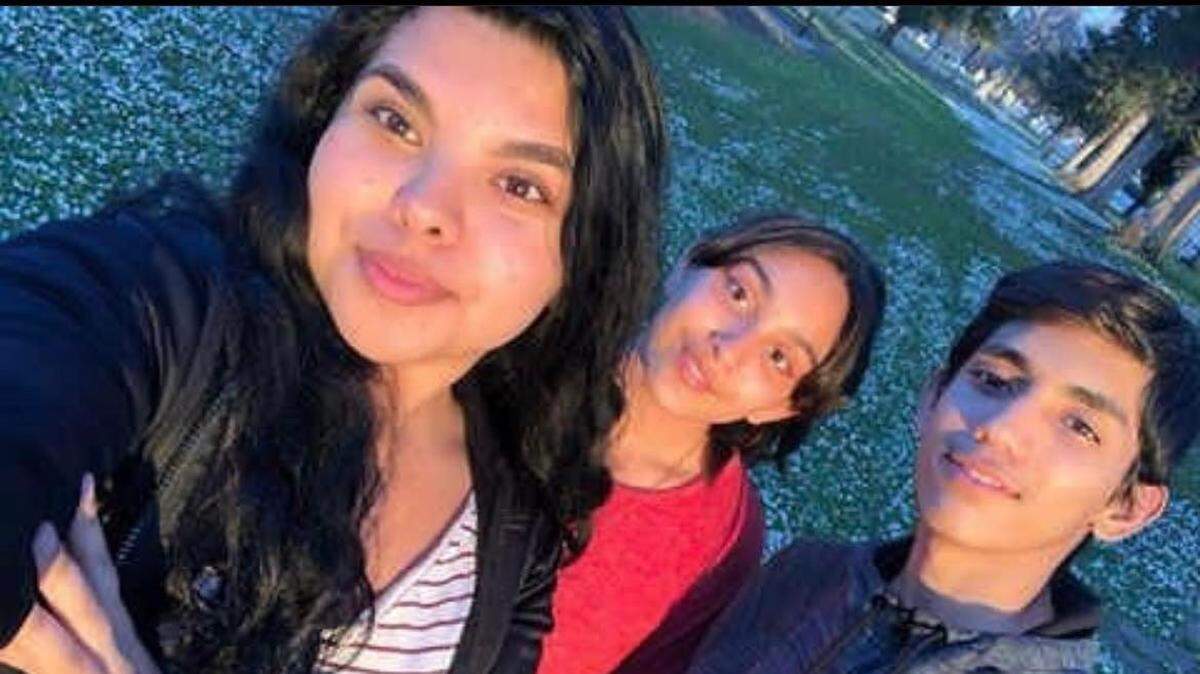 In this undated photo provided by his family, Angel Dominguez Jr., right, is pictured with his sisters Selena, left, and Raquel.