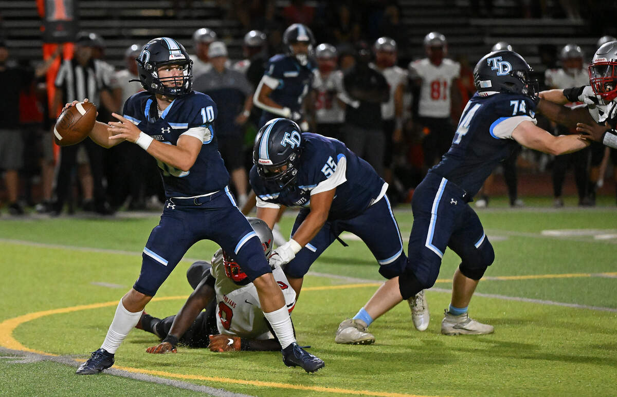 Downey quarterback Carson Lamb makes a pass during the game with Lincoln at Downey High School in Modesto, Calif., Friday, August 18, 2023.