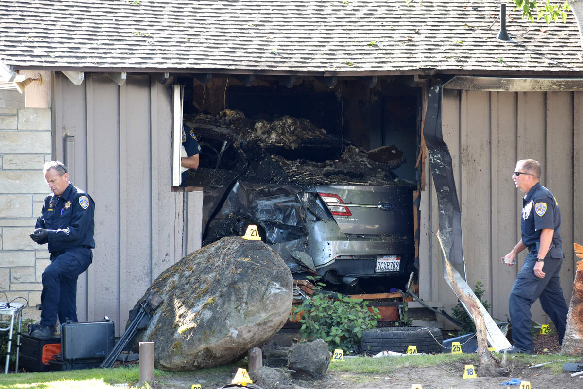 Members of the CHP’s major accident investigation team from Fresno work the scene of a crash into a home in Modesto’s Sherwood Forest neighborhood that killed a person early Tuesday, June 9, 2026. The house is on Tuxford Lane at the corner where it becomes Robin Hood Drive.