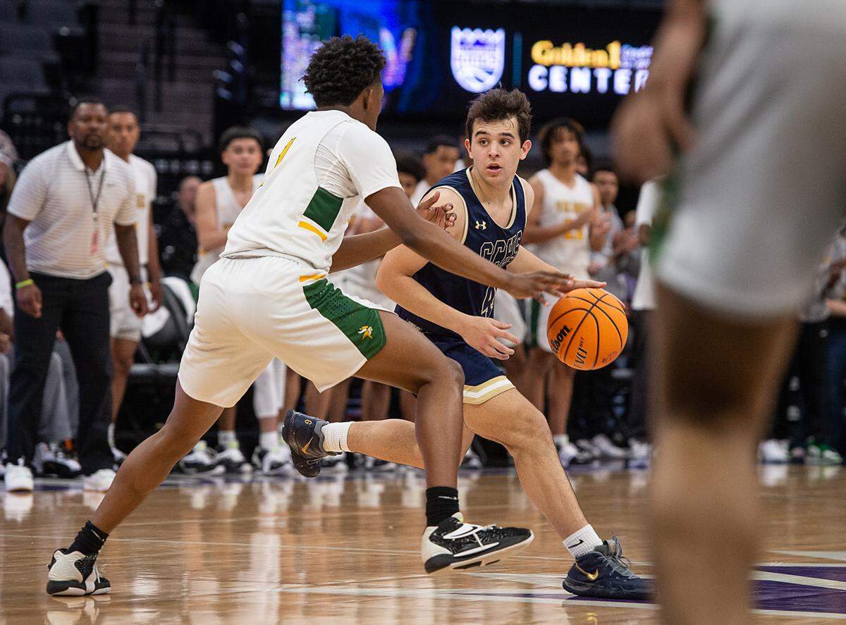 Central Catholic’s Julian Kuper looks to pass as he is defended by Mikey Johnson in the boys Sac-Joaquin Section Division 3 final with Vanden at the Golden 1 Center in Sacramento, Calif., on Saturday, Feb. 26, 2022.
