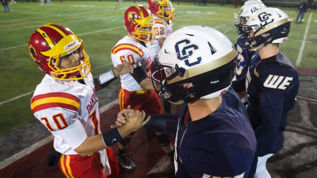 Central Catholic and Oakdale team captains meet at the 50-yard line during the Sac-Joaquin Division III final on Dec. 4, 2015. Central Catholic won, 21-7.