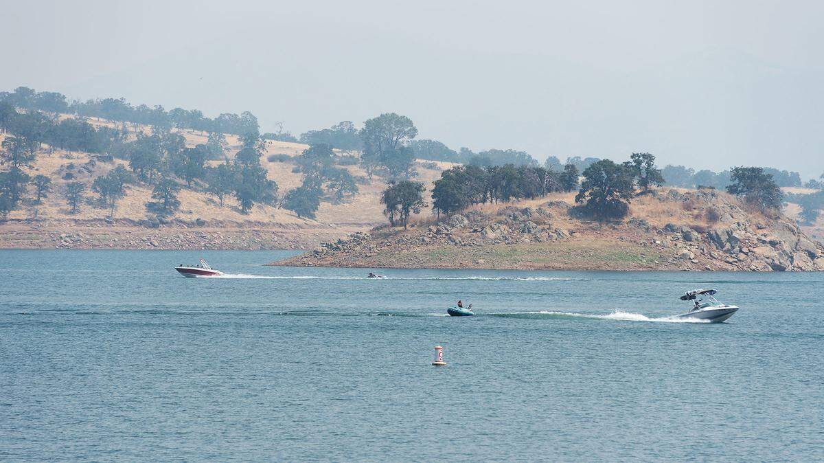 Smoke fills the air above Don Pedro Reservoir, Calif., Friday, July 20, 2018. 