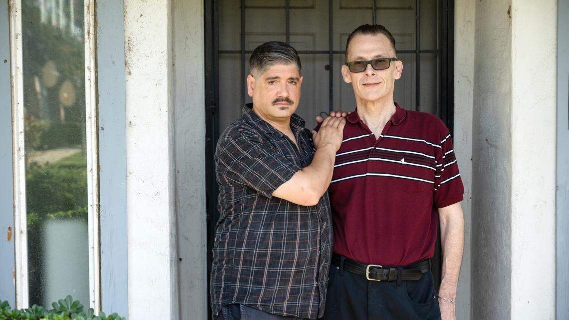David Cole, right, with his husband Moon Trent in Ceres, Calif., on Thursday, July 1, 2021. Cole a former Central Valley High teacher sued the City of Ceres, alleging a school resource officer harassed him in retaliation for reporting gay discrimination at school.