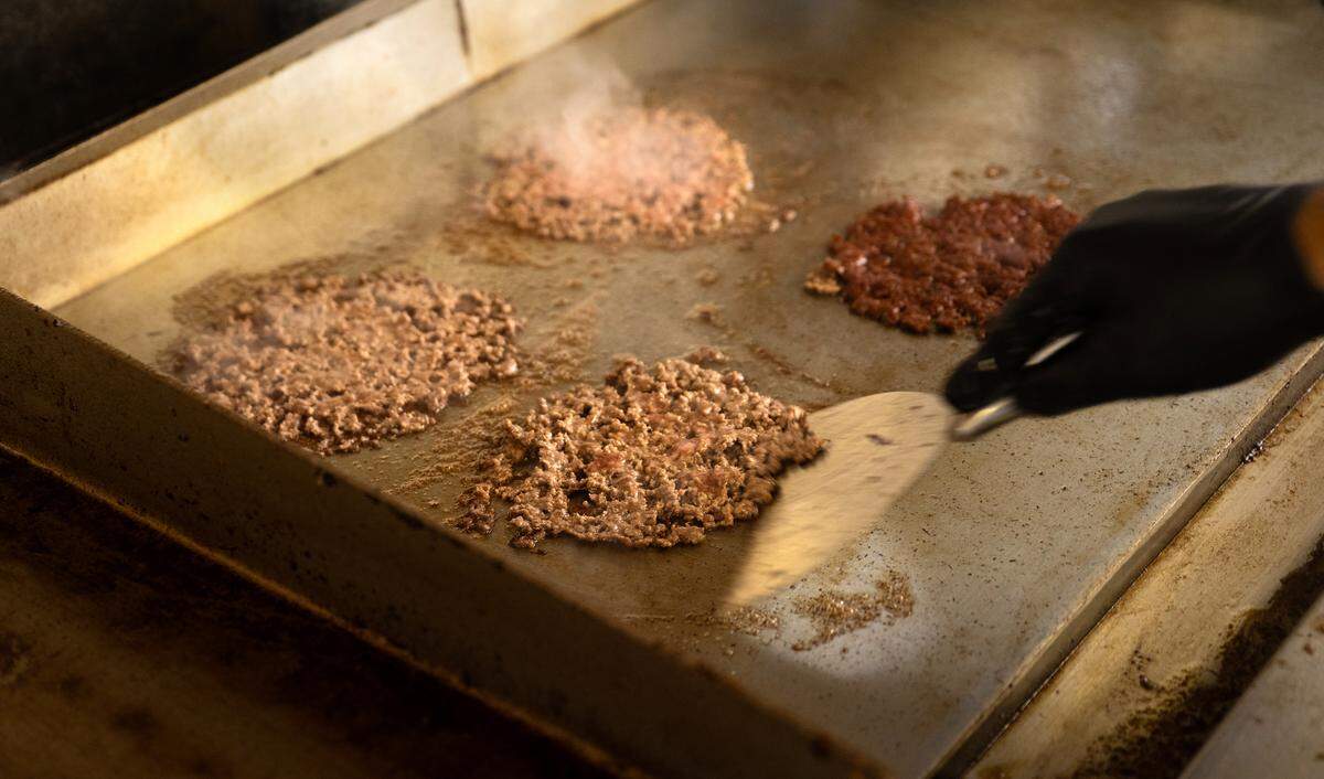 Smash burgers cook on the hot plate at Smash Bros Burgers in Merced, Calif., Tuesday, March 25, 2025.
