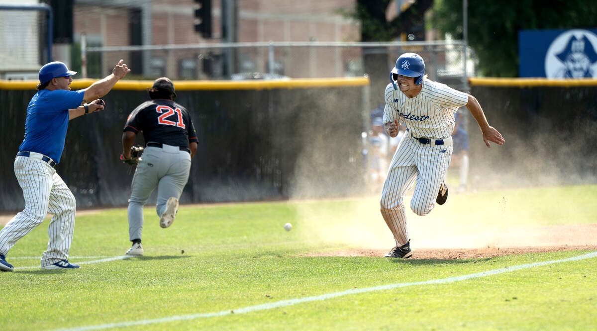 Modesto’s Troy Morrow scrambles home on a wild throw after stealing third base during the Northern California Regional playoff game with Reedley at Modesto Junior College on May 1, 2026. Modesto won the game 6-5.
